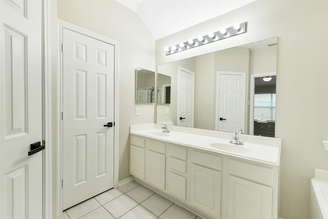 6611 Atasca Creek Dr, Humble, TX 77346 - full bath with double vanity, tile patterned floors, and vaulted ceiling
