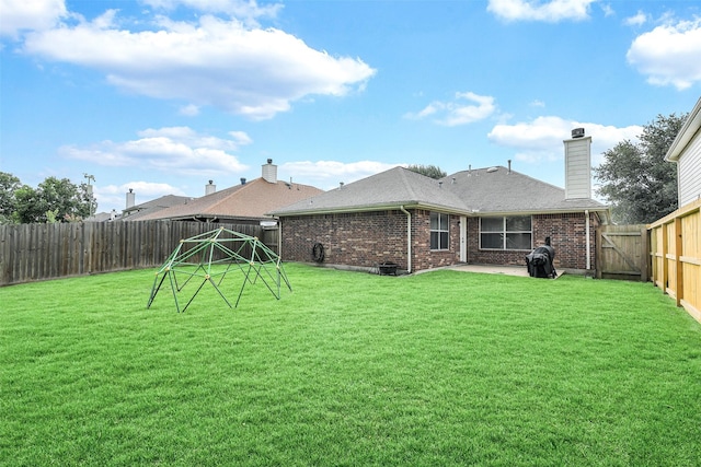 6611 Atasca Creek Dr, Humble, TX 77346 - rear view of house featuring brick siding, a patio, a fenced backyard, a chimney, and roof with shingles