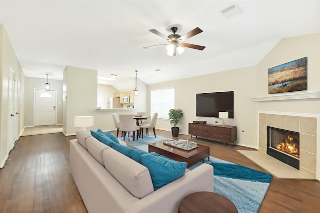 6611 Atasca Creek Dr, Humble, TX 77346 - living room with lofted ceiling, ceiling fan, wood finished floors, and a fireplace