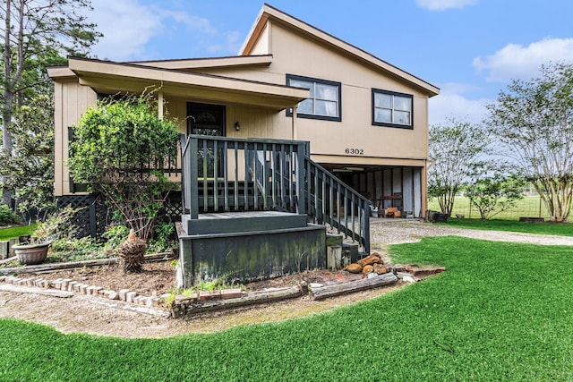 6302 Amie Ln, Pearland, TX 77584 - view of front of home with a front lawn, dirt driveway, a carport, stairway, and a porch