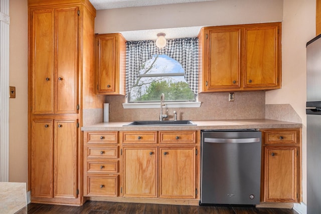 6302 Amie Ln, Pearland, TX 77584 - kitchen featuring dishwasher, tasteful backsplash, light countertops, brown cabinets, and dark wood finished floors