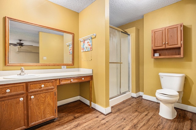 6302 Amie Ln, Pearland, TX 77584 - bathroom with a textured ceiling, wood finished floors, vanity, a shower stall, and a ceiling fan