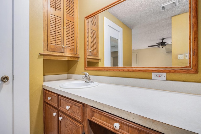 6302 Amie Ln, Pearland, TX 77584 - bathroom with a textured ceiling, vanity, and ceiling fan