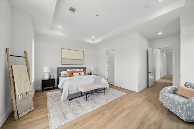 408 E 33rd St, Houston, TX 77018 - bedroom featuring light wood-style floors, a tray ceiling, and recessed lighting