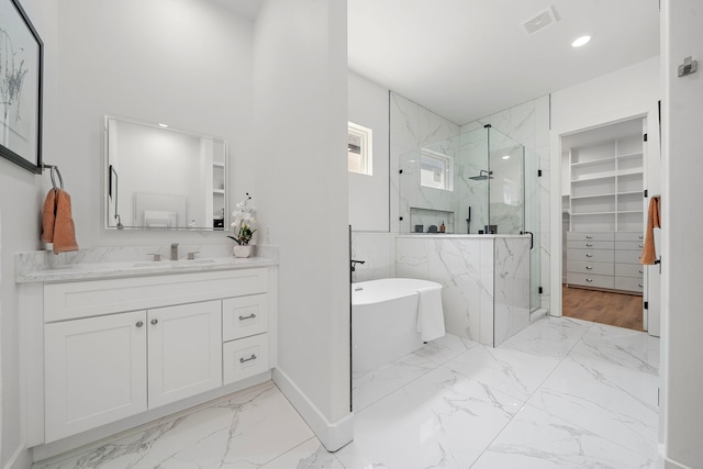 408 E 33rd St, Houston, TX 77018 - bathroom with a marble finish shower, marble look tiles, a freestanding bath, vanity, and a spacious closet