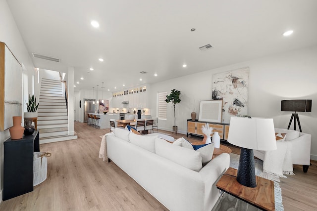 408 E 33rd St, Houston, TX 77018 - living area with recessed lighting, light wood-style floors, and stairway