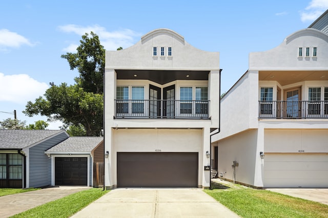 4106 Kolb St, Houston, TX 77007 - view of front of house featuring a balcony, stucco siding, concrete driveway, and a garage