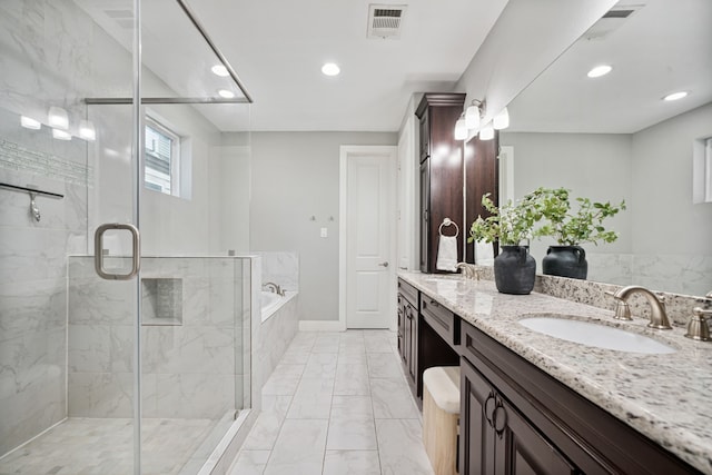 4106 Kolb St, Houston, TX 77007 - full bath featuring double vanity, a bath, marble finish flooring, a stall shower, and recessed lighting