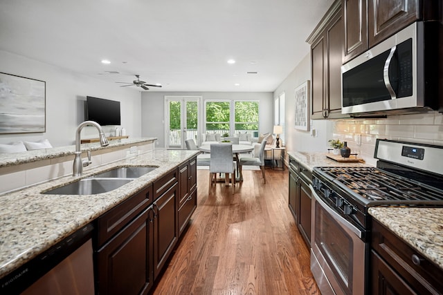 4106 Kolb St, Houston, TX 77007 - kitchen featuring appliances with stainless steel finishes, open floor plan, dark wood-type flooring, dark brown cabinets, and ceiling fan
