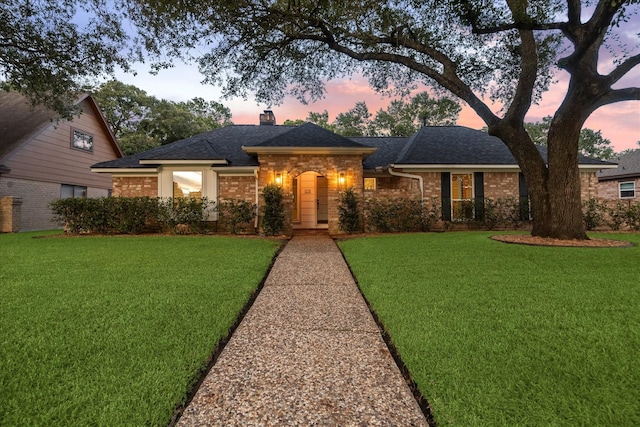 735 Rennie Dr, Katy, TX 77450 - view of front of home with a chimney, a yard, a shingled roof, and brick siding