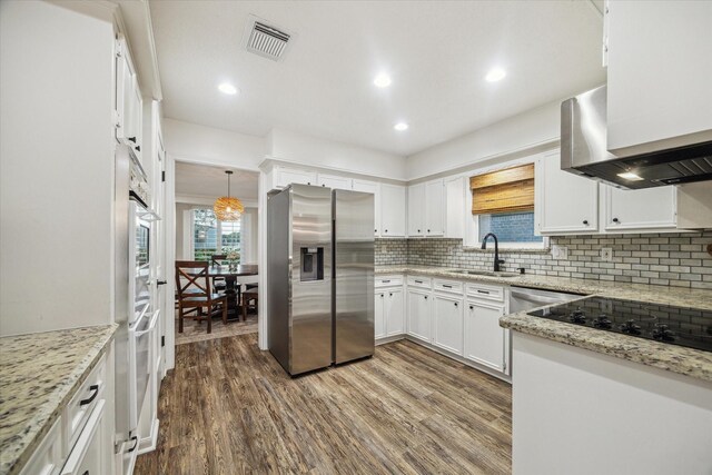 735 Rennie Dr, Katy, TX 77450 - kitchen with stainless steel fridge with ice dispenser, tasteful backsplash, white cabinetry, dark wood-style floors, and recessed lighting