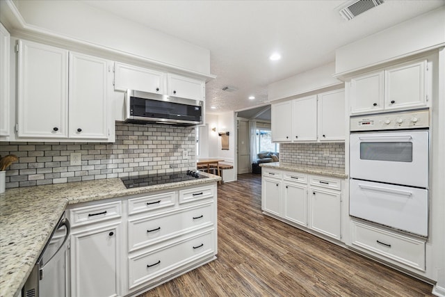 735 Rennie Dr, Katy, TX 77450 - kitchen with appliances with stainless steel finishes, recessed lighting, white cabinetry, and dark wood-style flooring
