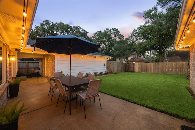 735 Rennie Dr, Katy, TX 77450 - patio terrace at dusk with a patio area, a fenced backyard, and outdoor dining area