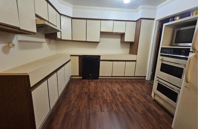 4721 Paradise Ln, Houston, TX 77048 - kitchen featuring stainless steel microwave, ornamental molding, white cabinetry, dark wood finished floors, and white double oven