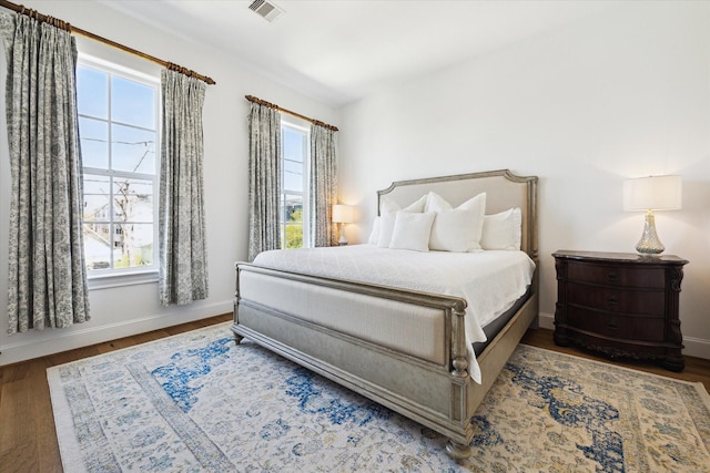 1240 W 16th St, Houston, TX 77008 - bedroom featuring multiple windows and wood finished floors