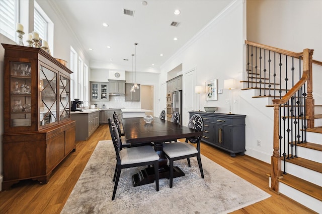 1240 W 16th St, Houston, TX 77008 - dining area featuring ornamental molding, stairs, light wood finished floors, and recessed lighting