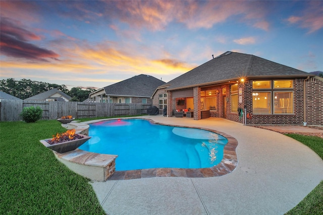 15715 Holloway Creek Ct, Houston, TX 77044 - pool at dusk featuring a fire pit, a fenced backyard, and a patio area