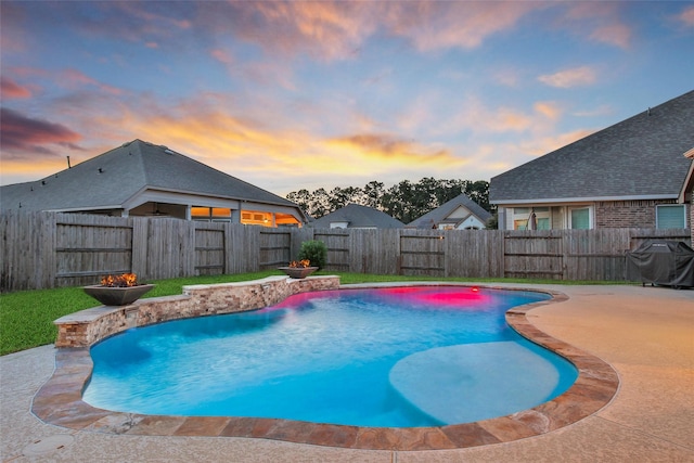 15715 Holloway Creek Ct, Houston, TX 77044 - pool at dusk featuring a fenced backyard, a patio area, and a grill