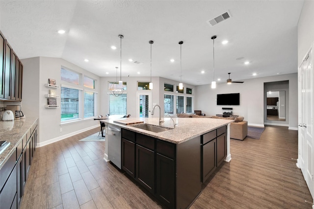 15715 Holloway Creek Ct, Houston, TX 77044 - kitchen with stainless steel dishwasher, dark wood-type flooring, light stone countertops, a center island with sink, and recessed lighting