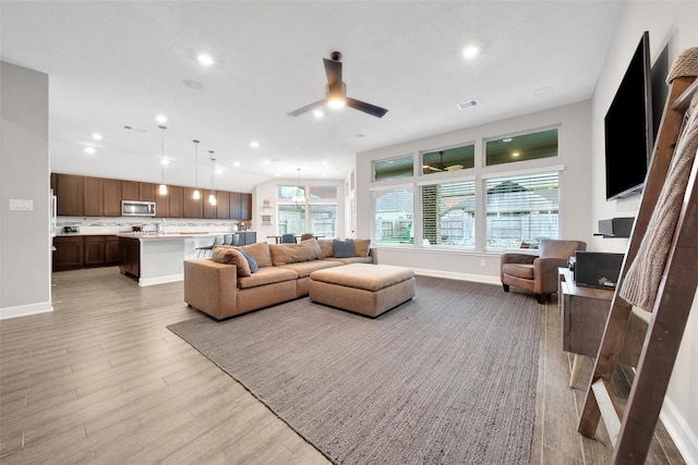 15715 Holloway Creek Ct, Houston, TX 77044 - living area featuring a ceiling fan, light wood-type flooring, and recessed lighting