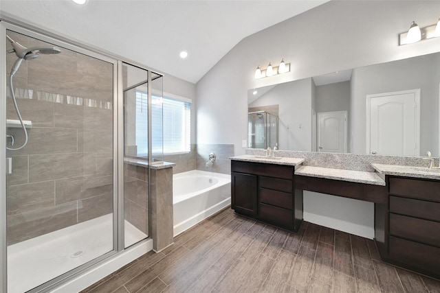 15715 Holloway Creek Ct, Houston, TX 77044 - full bathroom featuring a bath, vanity, a shower stall, lofted ceiling, and wood finished floors