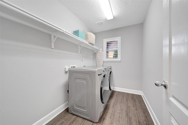 15715 Holloway Creek Ct, Houston, TX 77044 - laundry room with washer and dryer and wood finished floors