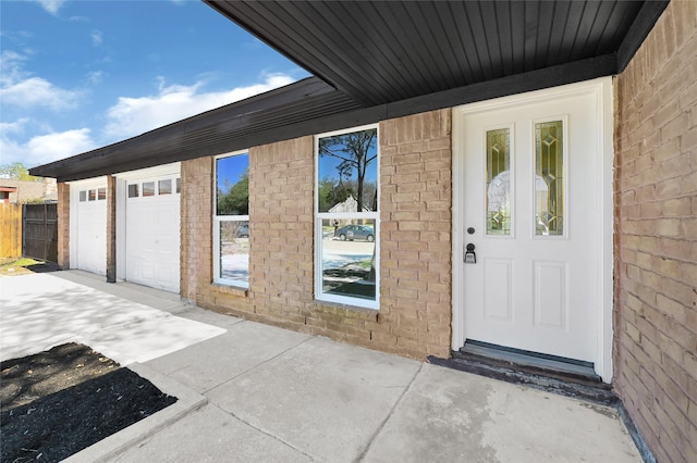 11807 Oceanview St, Missouri City, TX 77071 - doorway to property featuring a garage and brick siding