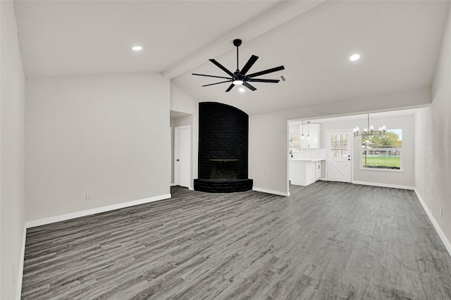 11807 Oceanview St, Missouri City, TX 77071 - unfurnished living room featuring a ceiling fan, wood finished floors, beamed ceiling, a brick fireplace, and a chandelier