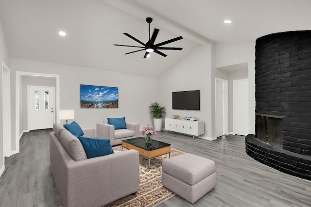 11807 Oceanview St, Missouri City, TX 77071 - living room featuring a ceiling fan, wood finished floors, beamed ceiling, a brick fireplace, and high vaulted ceiling