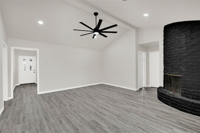 11807 Oceanview St, Missouri City, TX 77071 - unfurnished living room featuring ceiling fan, beam ceiling, a fireplace, wood finished floors, and recessed lighting
