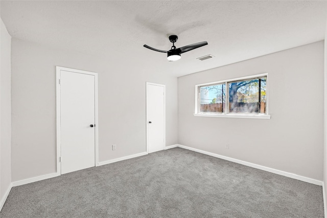 11807 Oceanview St, Missouri City, TX 77071 - unfurnished bedroom featuring carpet flooring, a ceiling fan, and a textured ceiling