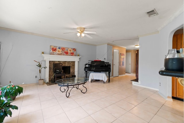 6619 Amberfield Ln, Katy, TX 77449 - living area with a ceiling fan, crown molding, a premium fireplace, arched walkways, and light tile patterned floors