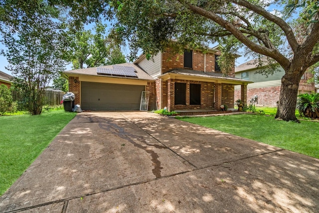 6619 Amberfield Ln, Katy, TX 77449 - view of front of property with brick siding, a front yard, an attached garage, solar panels, and driveway