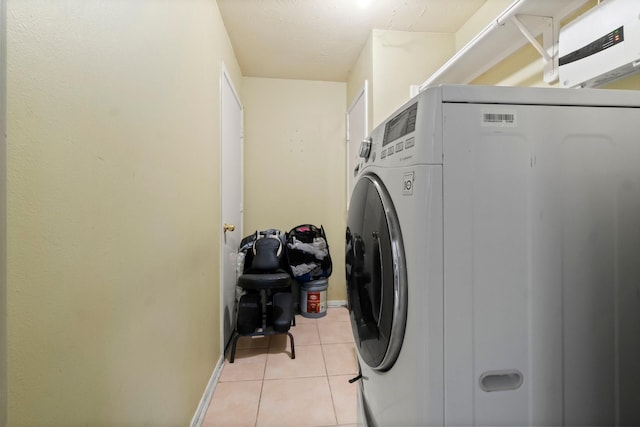 6619 Amberfield Ln, Katy, TX 77449 - laundry area with washer / dryer and light tile patterned floors