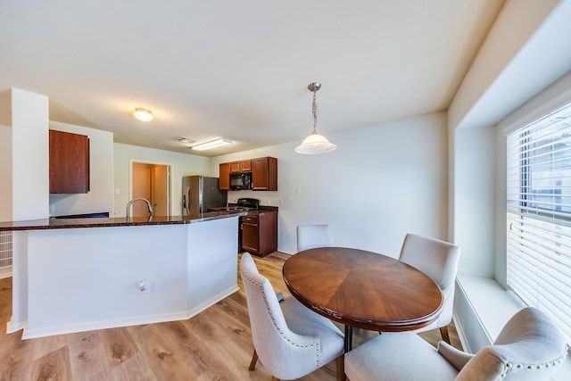 9415 Cholla Hill Ct, Houston, TX 77064 - dining area featuring light wood-style flooring and baseboards