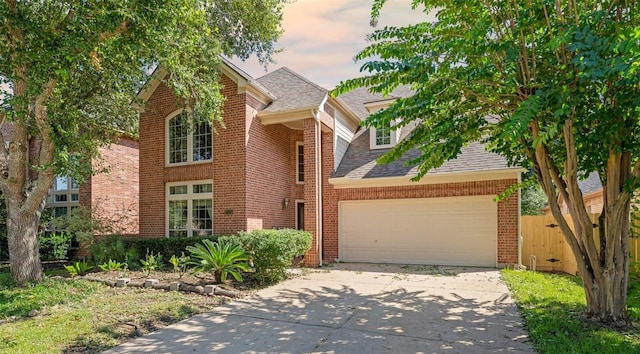 21331 Willow Glade Dr, Katy, TX 77450 - traditional-style home featuring an attached garage, driveway, brick siding, and a shingled roof