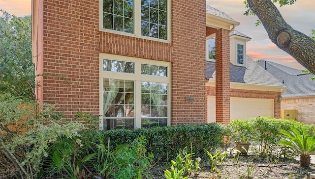 21331 Willow Glade Dr, Katy, TX 77450 - property entrance with brick siding, roof with shingles, and a garage