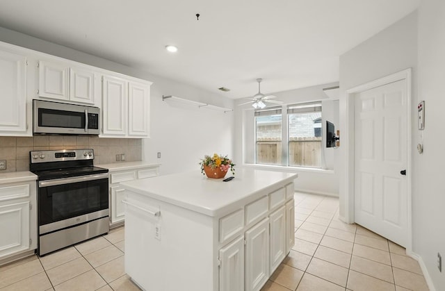 21331 Willow Glade Dr, Katy, TX 77450 - kitchen with appliances with stainless steel finishes, light tile patterned floors, tasteful backsplash, ceiling fan, and recessed lighting
