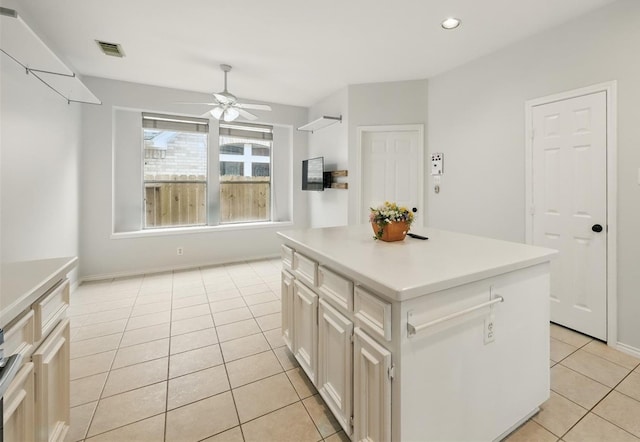 21331 Willow Glade Dr, Katy, TX 77450 - kitchen with a ceiling fan, light tile patterned floors, a kitchen island, light countertops, and recessed lighting