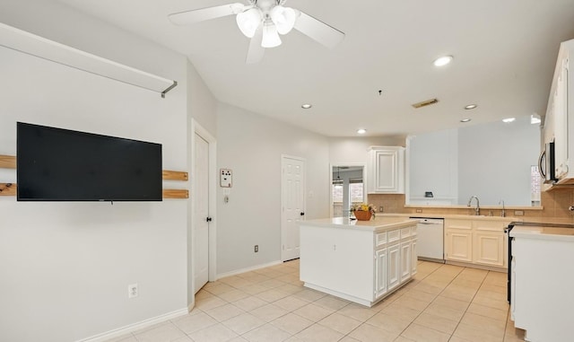 21331 Willow Glade Dr, Katy, TX 77450 - kitchen with white dishwasher, backsplash, range with electric stovetop, ceiling fan, and recessed lighting