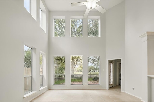 21331 Willow Glade Dr, Katy, TX 77450 - unfurnished living room with a high ceiling, ceiling fan, and tile patterned floors