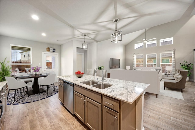 308 Spruce Oak Ln, Waller, TX 77484 - kitchen featuring dishwasher, light wood-style flooring, brown cabinets, recessed lighting, and decorative light fixtures