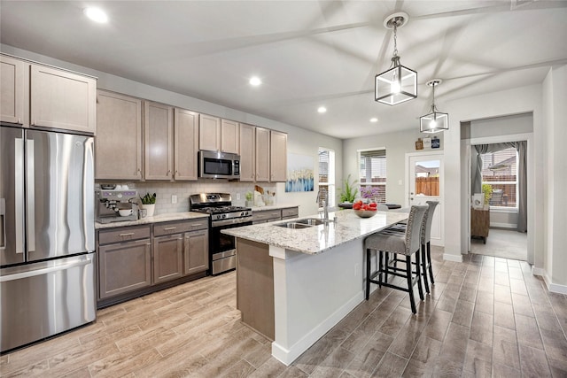308 Spruce Oak Ln, Waller, TX 77484 - kitchen featuring appliances with stainless steel finishes, light wood finished floors, recessed lighting, backsplash, and plenty of natural light