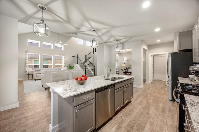 308 Spruce Oak Ln, Waller, TX 77484 - kitchen with stainless steel dishwasher, range with gas cooktop, ceiling fan, light wood-style floors, and recessed lighting
