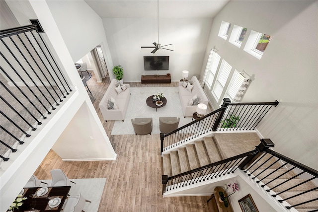 308 Spruce Oak Ln, Waller, TX 77484 - living area with stairs, a towering ceiling, wood finished floors, and a ceiling fan