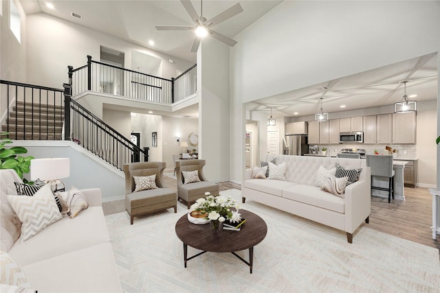 308 Spruce Oak Ln, Waller, TX 77484 - living room featuring recessed lighting, stairs, high vaulted ceiling, ceiling fan, and light wood-style flooring
