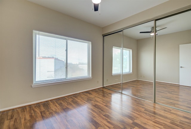 2213 S Braeswood Blvd Unit 13C, Houston, TX 77030 - unfurnished bedroom with wood finished floors, a closet, and a ceiling fan
