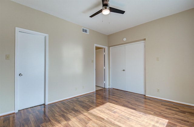 2213 S Braeswood Blvd Unit 13C, Houston, TX 77030 - unfurnished bedroom with wood finished floors, ceiling fan, and a closet