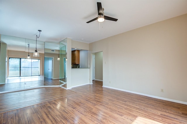 2213 S Braeswood Blvd Unit 13C, Houston, TX 77030 - unfurnished living room with a ceiling fan and wood finished floors