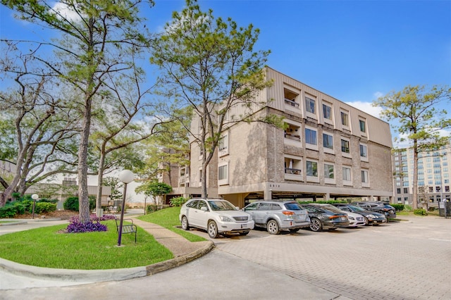 2213 S Braeswood Blvd Unit 13C, Houston, TX 77030 - view of building exterior featuring uncovered parking